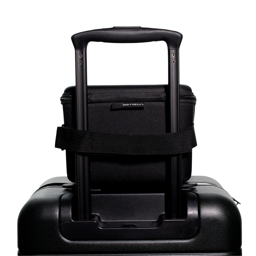 A close up view of the closed Melin 3 Hat Travel case in black attached to a suitcase Big Image - 4